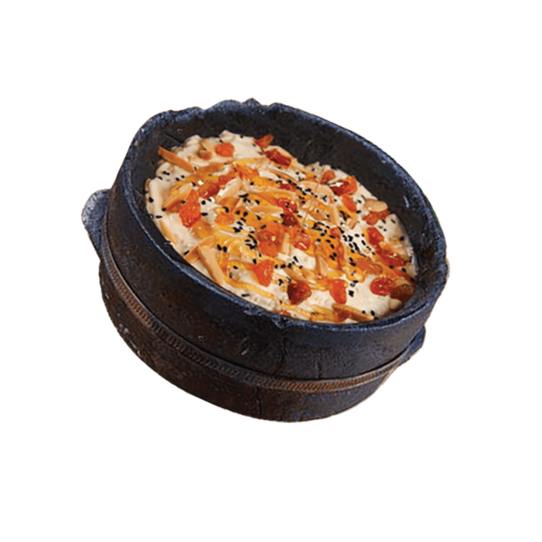 Banana Fattah (Soaked Bread Topped With Banana And Cream And Black Cinnamon)